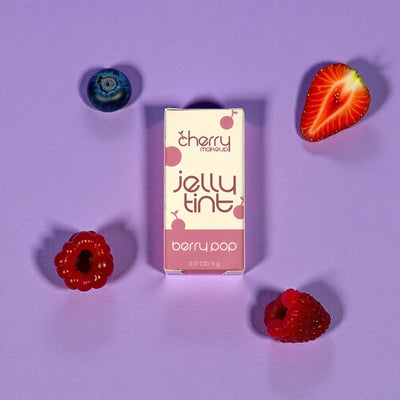Cherry Makeup Jelly Tint packaging with berries on a purple background