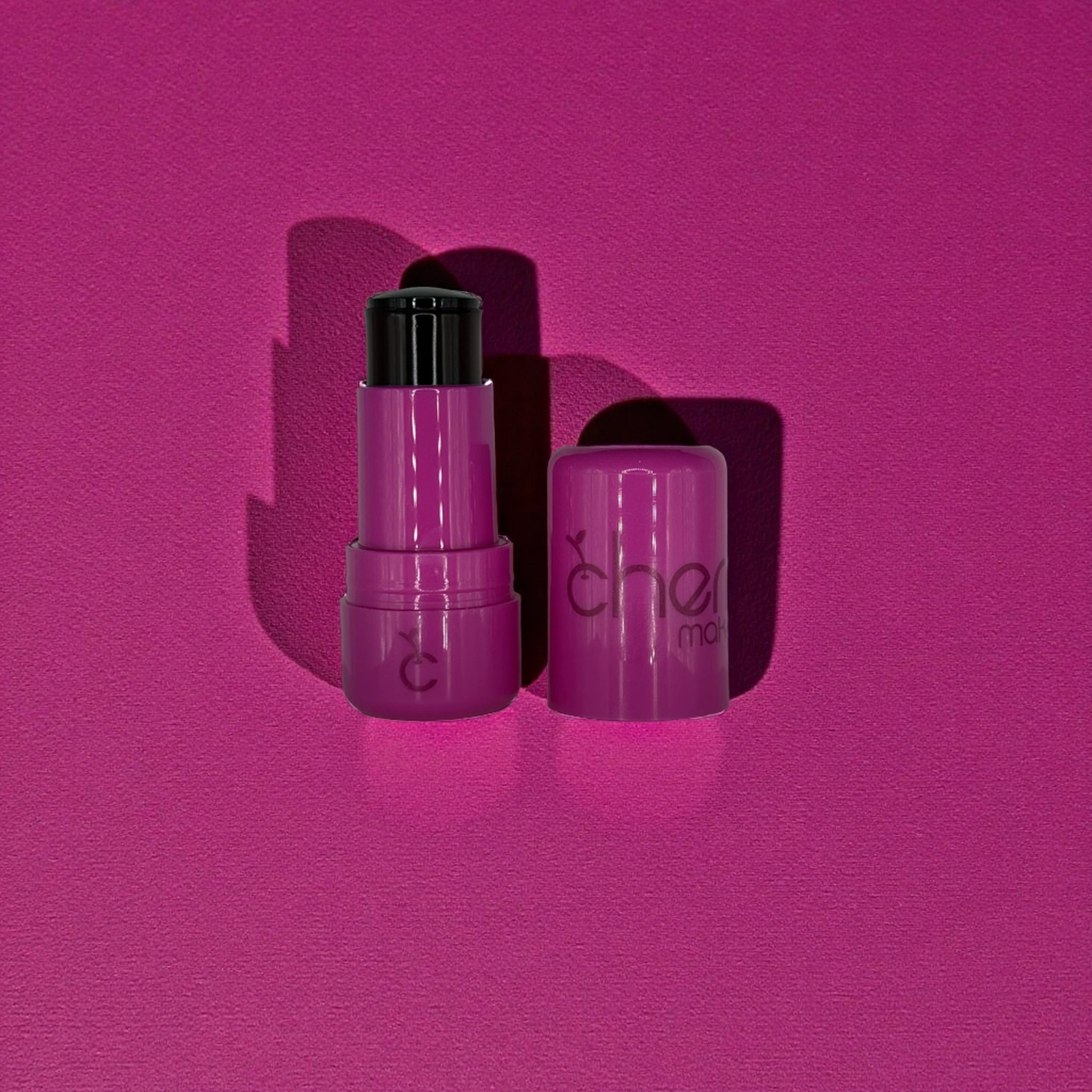 Two purple lip products with 'Cherry Makeup' branding on a pink background