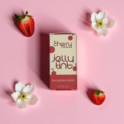 Cherry makeup jelly tint packaging with strawberries and flowers on a pink background